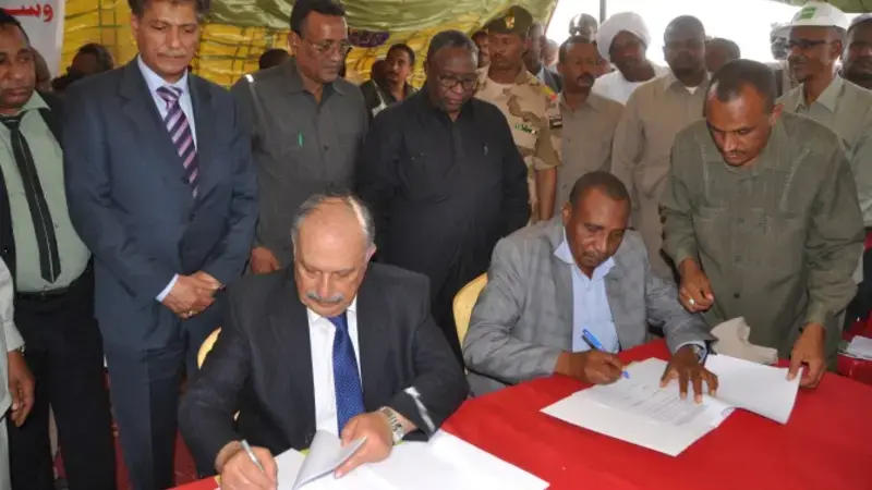 Signing the agreement.Pictured seated are Dr. Mahmoud Solh (Left) and Prof. Ibrahim Adam Eldukheri of ARC. Also pictured are H. E. Minister of Agriculture, Eng. Ibrahim Mahmoud Hamid, and Sudanese Vice-President, H. E. Hassabo Mohamed Abderahman. Signing the agreement.Pictured seated are Dr. Mahmoud Solh (Left) and Prof. Ibrahim Adam Eldukheri of ARC. Also pictured are H. E. Minister of Agriculture, Eng. Ibrahim Mahmoud Hamid, and Sudanese Vice-President, H. E. Hassabo Mohamed Abderahman.
