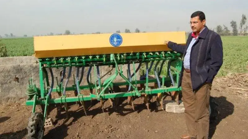 Dr. Atef Swelam with the raised-bed machine. Dr. Atef Swelam with the raised-bed machine.